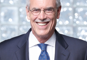 Former U.S Solicitor General Donald Verrilli Jr. in blue suit with a white shirt and blue tie/