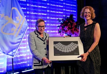 Dean Gillian Lester presents Ruth Bader Ginsburg with a custom made lace collar.