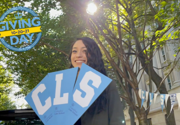 Student holding signs that say "C" "L" "S". Logo that reads Giving Day 10-20-21