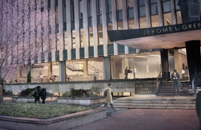 Rendering of a plaza with a tree in bloom and the exterior of the law school  