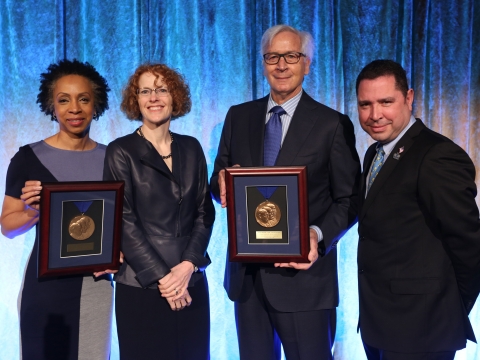2019 Medal for Excellence honorees Nina Shaw and Jonathan Schiller hold up their medals with Dean Gillian Lester.