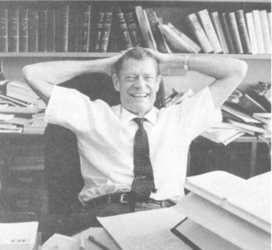 Archival black and white photo of Willis L.M. Reese sitting at a desk in front of a bookshelf.