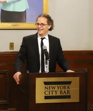 Professor Bernard Harcourt standard behind a podium reading "New York City Bar."
