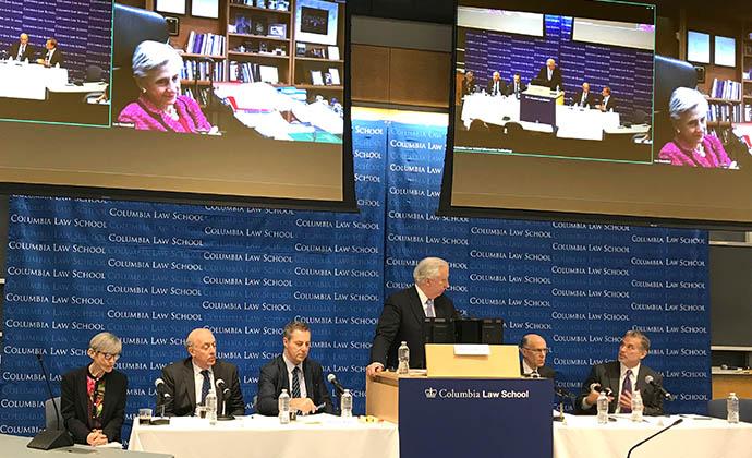 (Left to right) Elizabeth J. Cabraser, Samuel Issacharoff, Brad S. Karp, John C. Coffee Jr., Robert Klonoff, Chris Seeger, and, on the video screens, U.S. District Judge Lee H. Rosenthal for the Southern District of Texas 