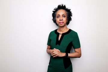 Portrait of Nina Shaw in a green and black dress