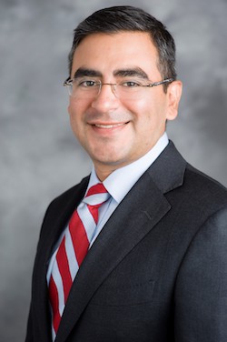 Man wearing glasses and striped tie