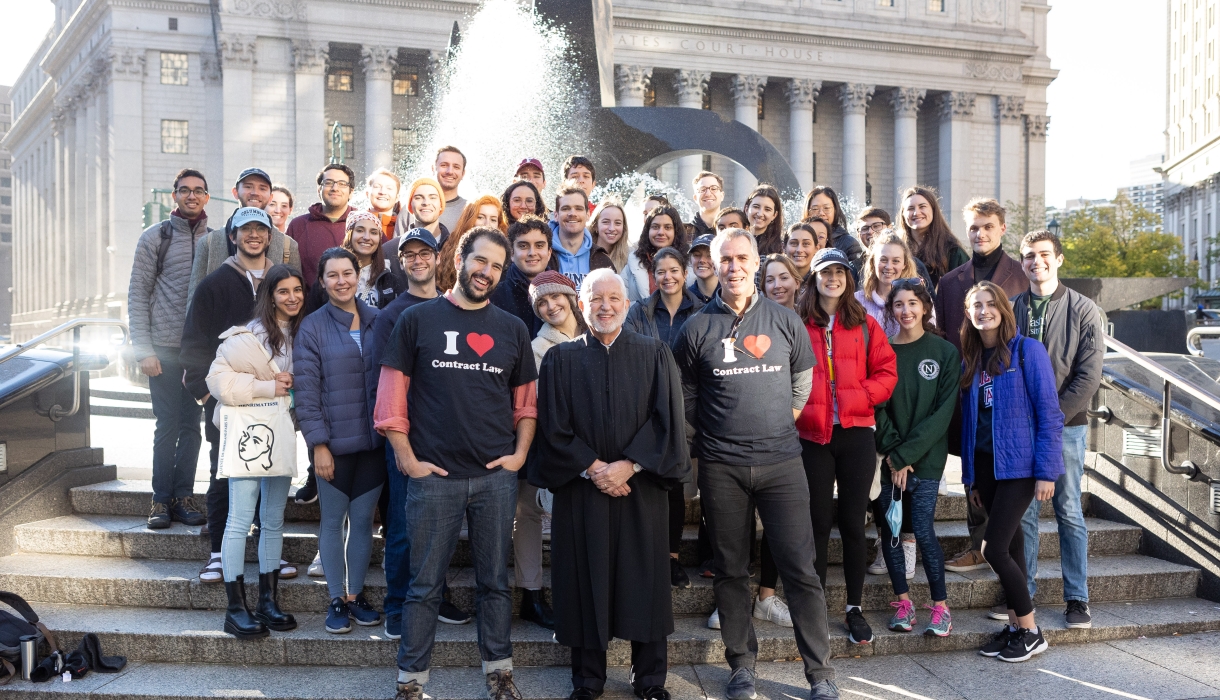 Students in the Contracts classes of Professor Eric Talley and Visiting Professor Julian Arato pose for a photo with Judge Jed Rakoff in front of the Thurgood Marshall United States Courthouse.