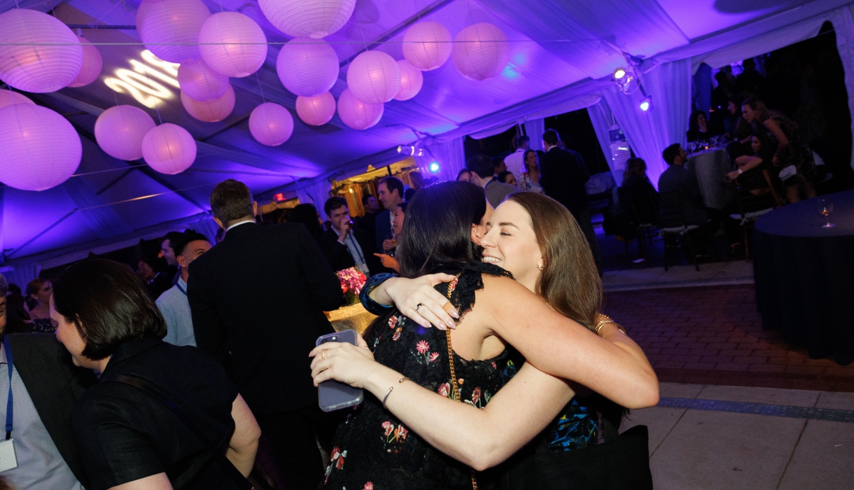 Women hugging in party tent