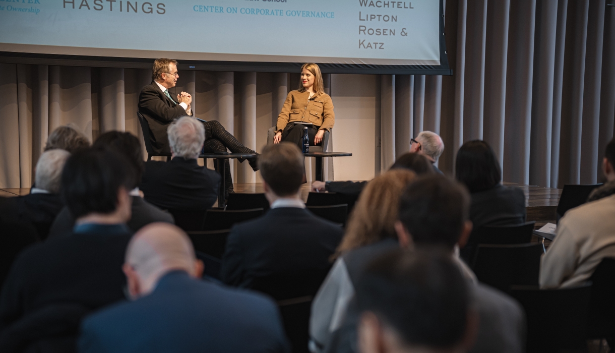 Man and woman onstage in conversation with audience.