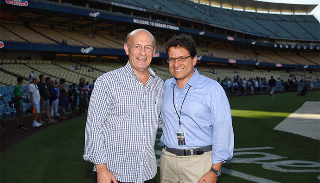 Stan Kasten and Mark Attanasio stand in Dodger Stadium.