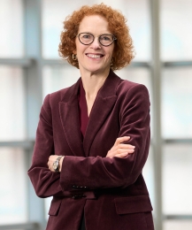 Gillian Lester smiling with crossed arms