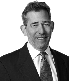 Pictured above is a black and white image of  Steven G. Horowitz in a suit and tie. 