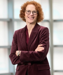 Gillian Lester smiling with crossed arms