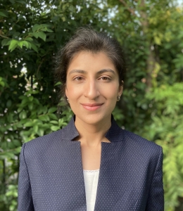 Columbia Law professor Lina Khan in blue jacket and white camisole