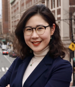 Claire Park ’21 in glasses and jacket with Amsterdam Avenue in background