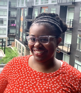 Monae White wearing glasses and a red-and-white shirt