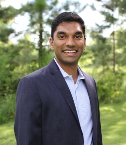 Rohan Naik smiling and wearing a blue suit