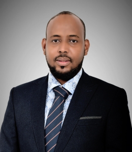 Man in a dark suit and striped tie