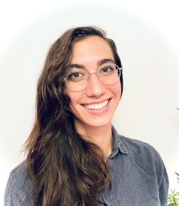 Young woman with wire rim glasses and long brown hair. 
