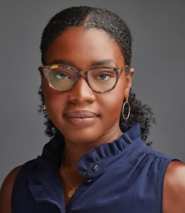 Headshot of a woman wearing glasses and a blue shirt