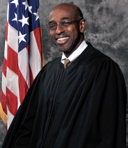 Judge Joseph A. Greenaway Jr. in robe in front of U.S. flag