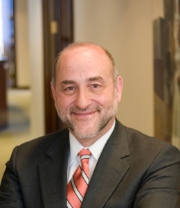 Portrait of a man wearing a suit and striped tie