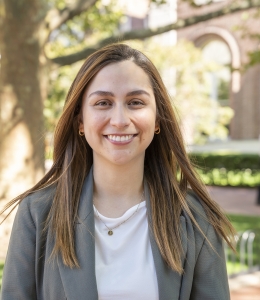 woman in a grey blazer and white shirt