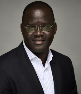 Photo of a man in a blazer and white shirt