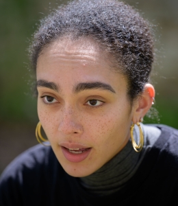 Young woman with gold hoop earrings. 