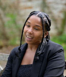 Young woman with braids smiling and talking