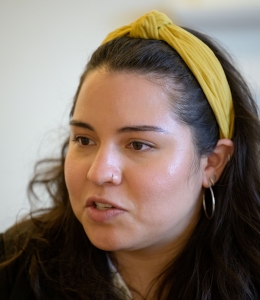 Young woman with yellow headband speaking