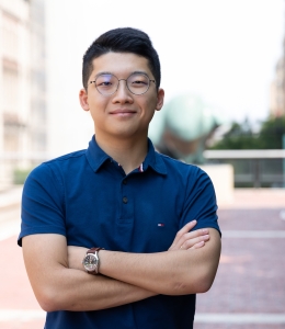 Man in glasses and short sleeve shirt crossing his arms