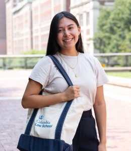 Student with Columbia Law bookbag standing outside