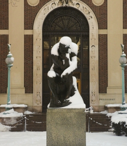 The Thinker statute covered in snow in front of Philosophy Hall.