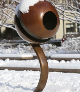 The Life Force statue, aka the eyeball, is covered in winter snow.