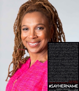 Woman with dreadlocks in pink shirt with book cover