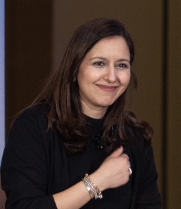 Woman in black shirt with hand over her heart