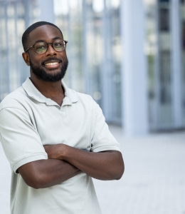 Man with eyeglasses outside in polo shirt