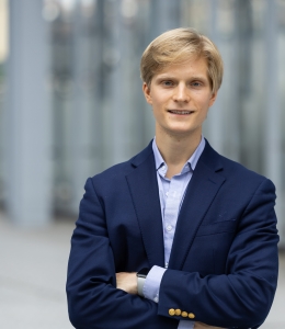 Man with blonde hair wearing navy blazer