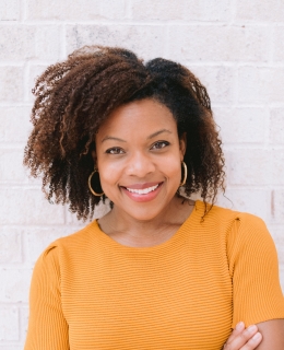 A woman in short sleeved orange dress