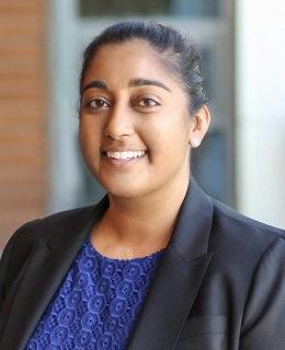 Woman in a blue blouse and black blazer