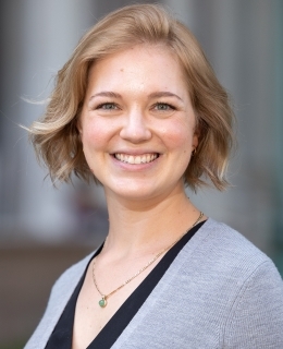 Amanda Roden wears a blue shirt with a grey cardigan and gold necklace