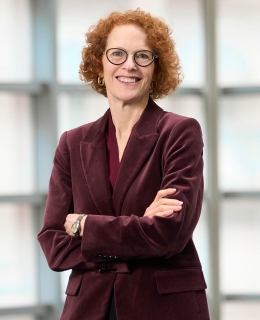 Gillian Lester smiling with crossed arms