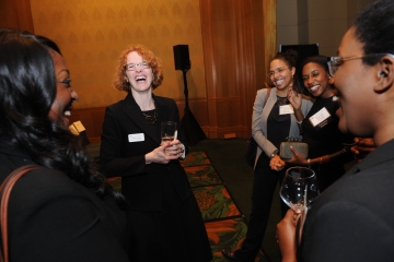 Group of women laughing at a reception