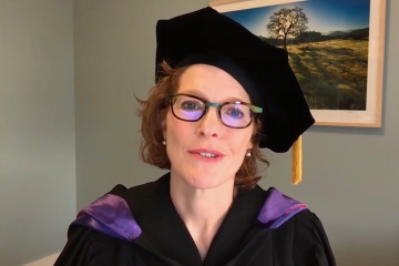 Woman in academic regalia at podium