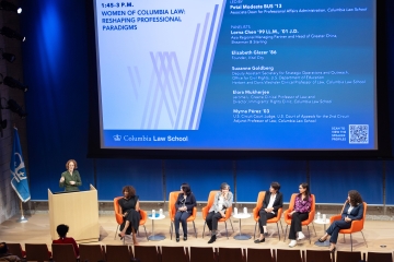 A panel discussion among women on a big stage