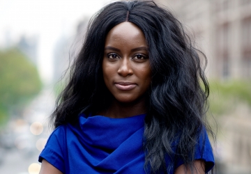 Columbia Law Review Editor in Chief Oluwatumise Asebiomo in blue dress