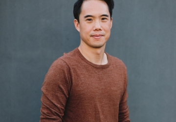 Dark-haired man in brown sweater