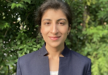 Columbia Law professor Lina Khan in blue jacket and white camisole