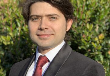 Dark-haired man in suit and tie